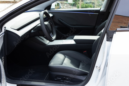 Car interior luxury inside. Steering wheel, dashboard, speedometer, display. Black leather interior. Modern luxury car Interior - steering wheel, shift lever and dashboard © uflypro