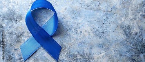 a colon cancer awareness symbol made with light blue coloured ribbon