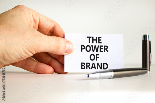 The power of brand symbol. Concept words The power of brand on beautiful white paper. Beautiful white background. Businessman hand. Business the power of brand concept. Copy space.