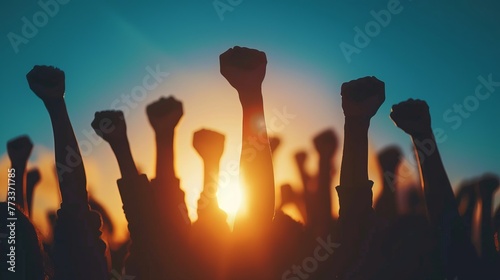 Arms raised in protest. Group of protestors fists raised up in the air photo