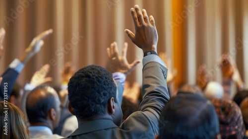 Multi-Ethnic Business Seminar: Rear View of Businesspeople Raising Hands © Maximilien
