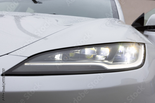 Modern car headlamp flashing light with blinking on continuously indicator. Switched on led matrix lights of luxury car. Car Blinker Light. Car front full led matrix IQ Light