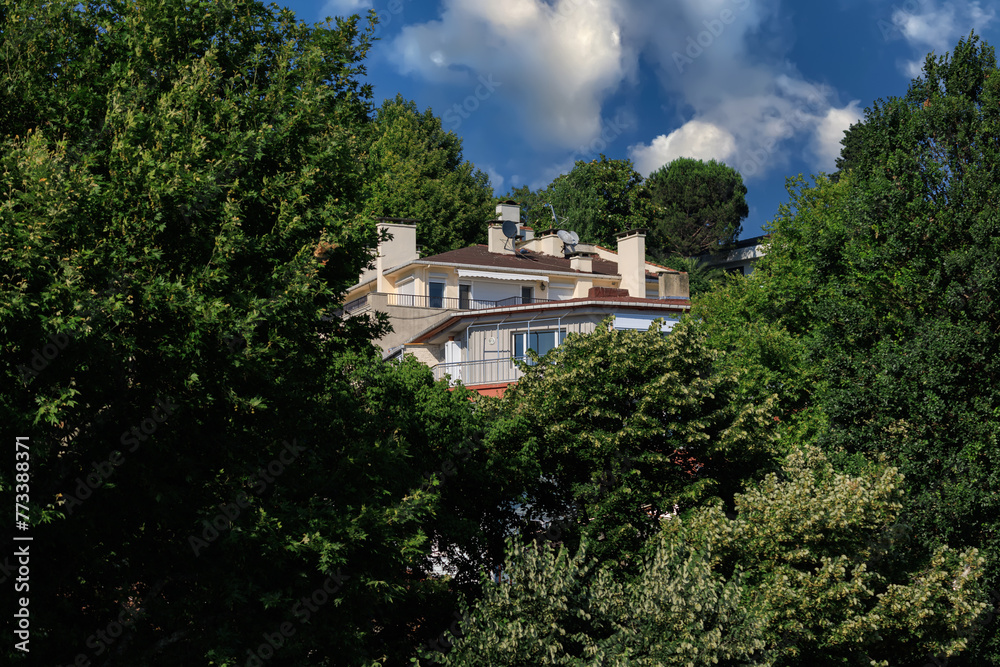 Beautiful houses and city streets of the southern city with green plants, public place in Turkey, on a summer sunny day Beautiful houses and city streets of the southern city with green plants, public place in Turkey, on a summer sunny day