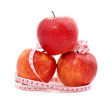 Fresh ripe red apples with measuring tape.