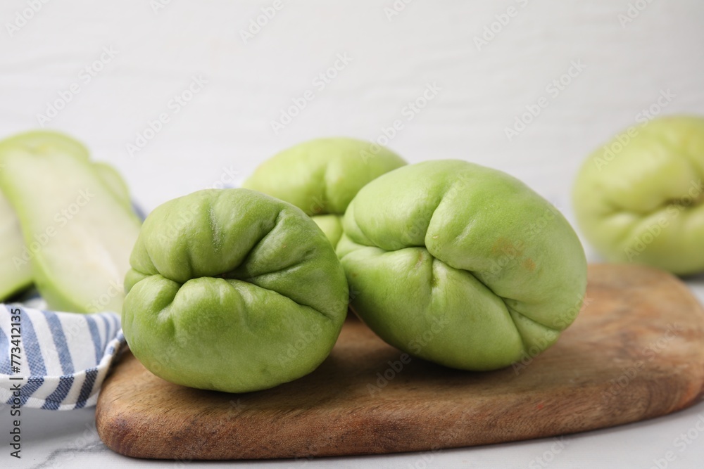 Fresh green chayote on light table, closeup Fresh green chayote on light table, closeup