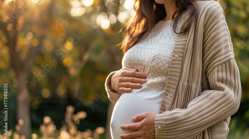 pregnant woman expecting her baby is touching her belly