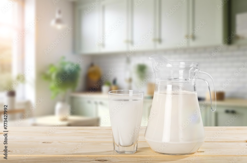 Tasty fresh Milk in jug and cup on the desk Tasty fresh Milk in jug and cup on the desk