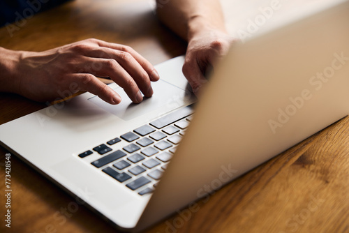 Close up of man using laptop photo