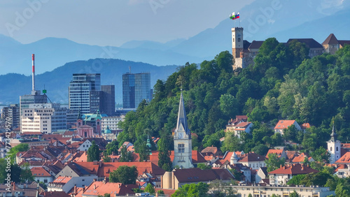 AERIAL: Panoramic vista of the Ljubljana cityscape with mountains in background
