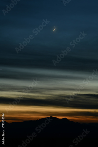 Crescent Sliver Moon Over Desert at Dusk 