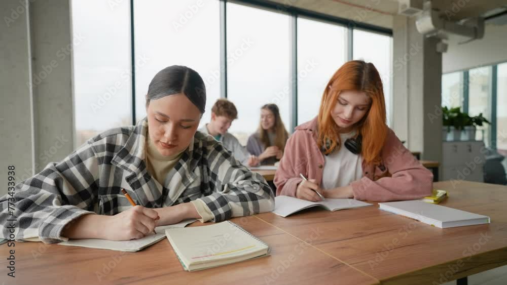 Exams. Students writing a test in their exercise books Exams. Students writing a test in their exercise books