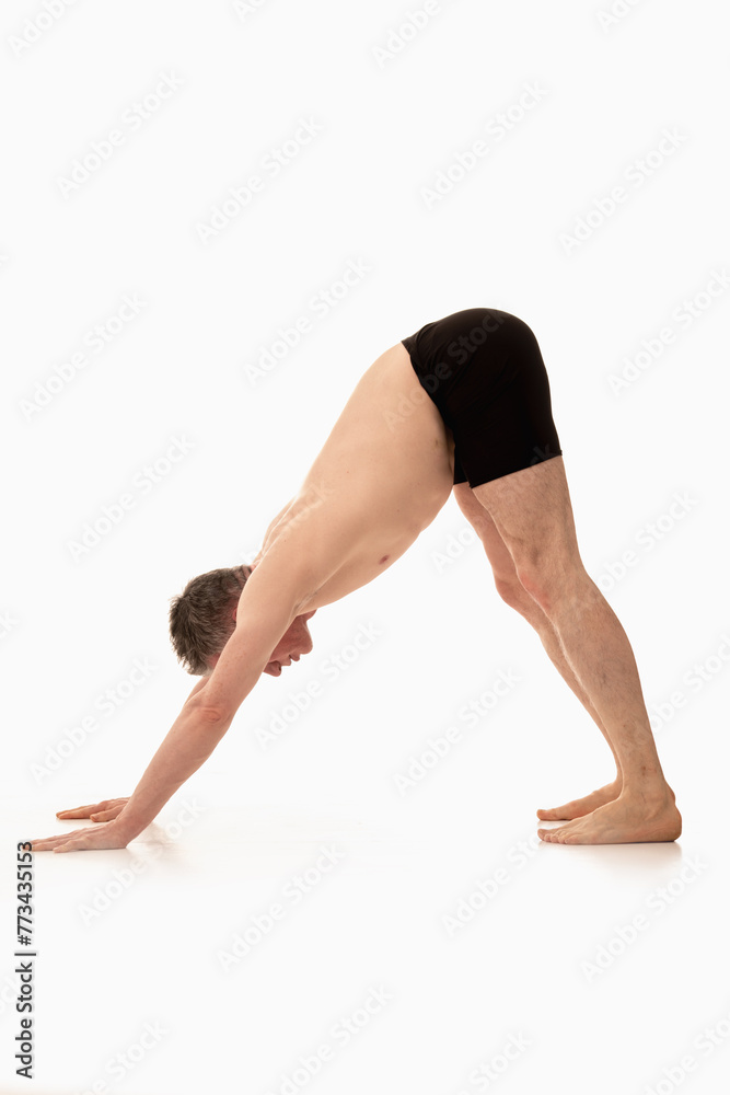 Adho Mukha Svanasana, Ashtanga yoga Side view of man wearing sportswear doing Yoga exercise against white background. Adho Mukha Svanasana, Ashtanga yoga Side view of man wearing sportswear doing Yoga exercise against white background.