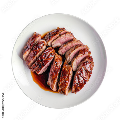 Sizzling grilled duck breast, skin scored and rendered to a crisp, medium rare, sliced thin, with a balsamic glaze, on a white plate.