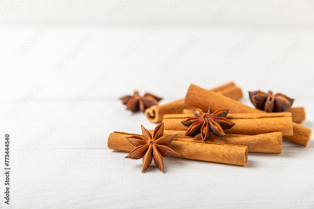 Cinnamon sticks and anise on a textured background. Cinnamon roll and star anise. Spicy spice for baking, desserts and drinks. Fragrant ground cinnamon.Place for text. copy space. Cinnamon sticks and anise on a textured background. Cinnamon roll and star anise. Spicy spice for baking, desserts and drinks. Fragrant ground cinnamon.Place for text. copy space.