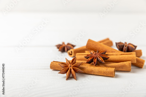 Cinnamon sticks and anise on a textured background. Cinnamon roll and star anise. Spicy spice for baking, desserts and drinks. Fragrant ground cinnamon.Place for text. copy space.