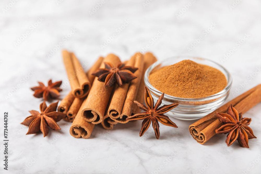 Cinnamon sticks and anise on a textured background. Cinnamon roll and star anise. Spicy spice for baking, desserts and drinks. Fragrant ground cinnamon.Place for text. copy space. Cinnamon sticks and anise on a textured background. Cinnamon roll and star anise. Spicy spice for baking, desserts and drinks. Fragrant ground cinnamon.Place for text. copy space.