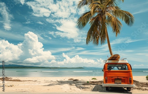 An orange van is parked on a sandy beach beside a tall palm tree under the bright sun © pham