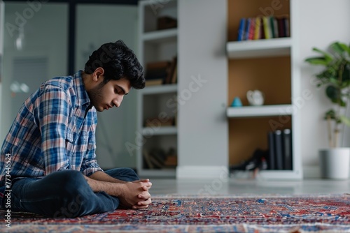 young arab muslim man reading the holy quran in the office