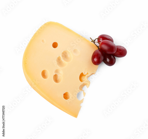 Piece of delicious cheese and grapes isolated on white, top view