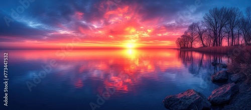 Beautiful view on lake landscape and colorful sunset with water reflection