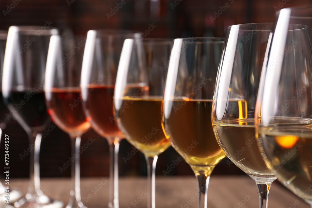 Naklejka premium Different tasty wines in glasses against blurred background