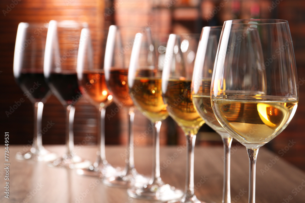Different tasty wines in glasses on table Different tasty wines in glasses on table