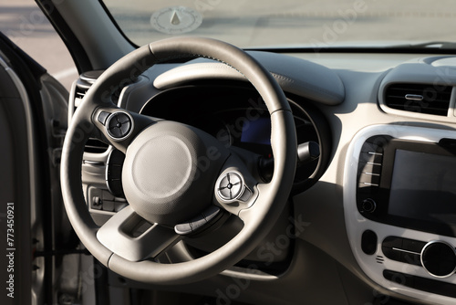 Black steering wheel and dashboard in modern car © New Africa