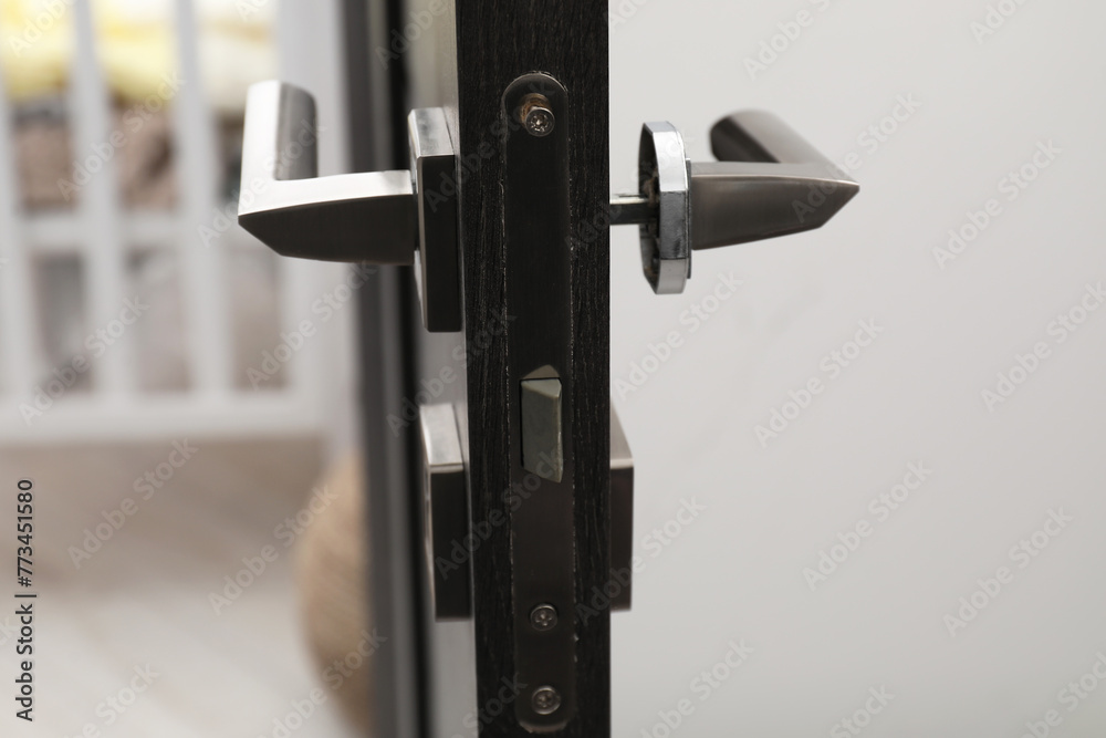 Wooden door with broken handle indoors, closeup Wooden door with broken handle indoors, closeup