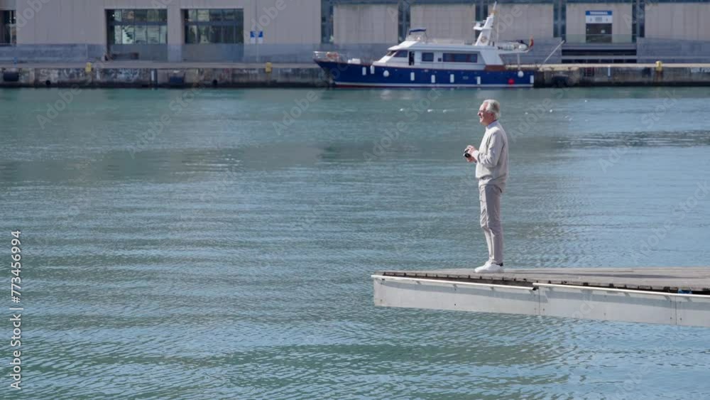 Full body length of mature tourist taking a photograph in a quay. Stock ビデオ | Adobe Stock
