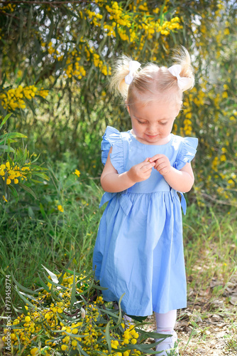 girl draws in nature.  Little girl in a blue dress