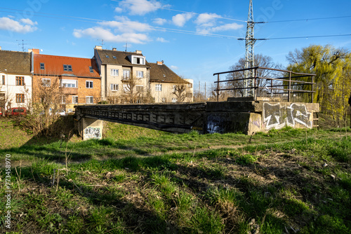 Brno, Czech Republic - Old concrete bridge over the river on the embankment street with family houses.