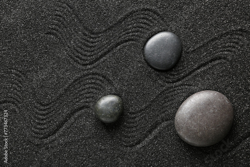 Canvas Print Spa stones on black sand with lines. Zen concept
