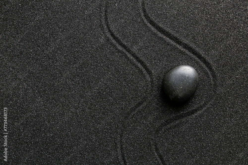 Spa stone on black sand with lines. Zen concept Spa stone on black sand with lines. Zen concept