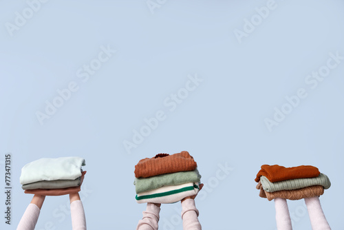 Hands holding stacked folde...