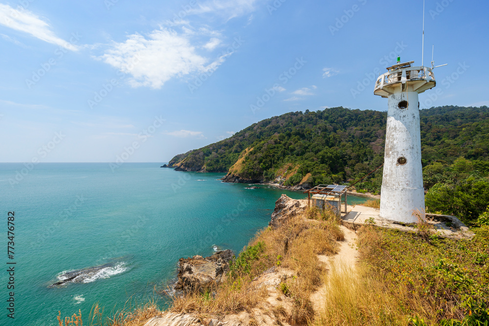 Scenic view of a lighthouse on a cliff at the Mu Ko Lanta National Park in Koh Lanta, Thailand, on a sunny day.