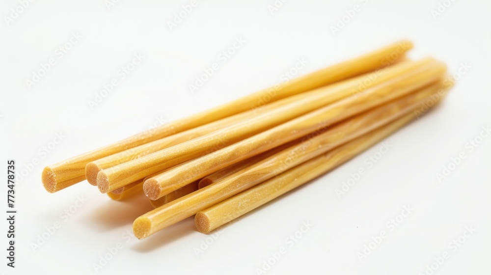 A bunch of bamboo sticks on a white surface. Suitable for backgrounds or nature-themed designs