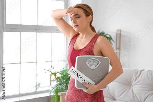 Sporty mature woman holding...