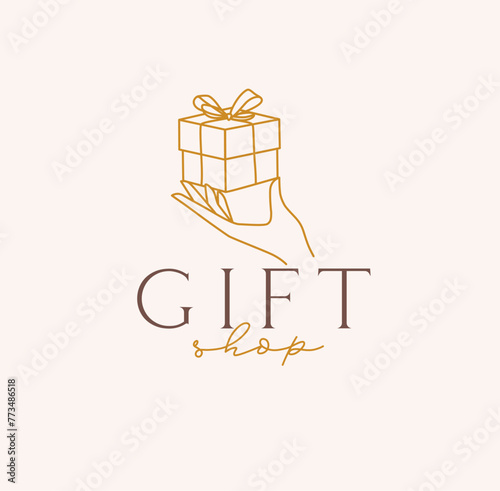 Obraz na płótnie Hand holding gift box with lettering gift shop drawing in linear style on beige background w salonie