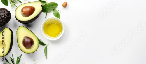 Avocado and a bottle of olive oil placed on a plain white background, providing a simple and clean image for food concepts