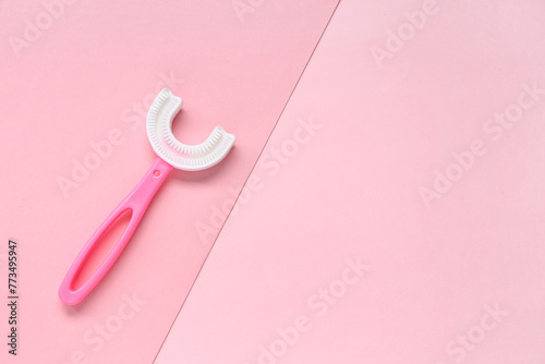 Children's toothbrush on pink background