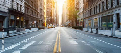 A quiet New York city street in summer with a view of the bright sun