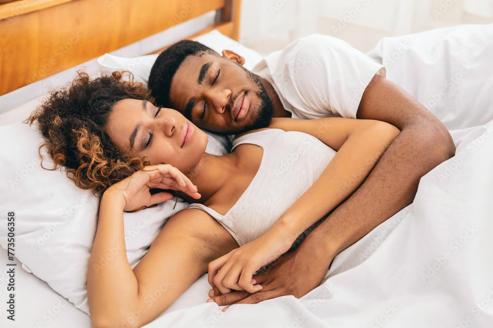 Couple in a tender embrace on white sheets Couple in a tender embrace on white sheets