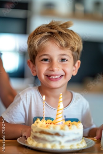 A young boy sitting in front of a birthday cake. Perfect for birthday celebrations