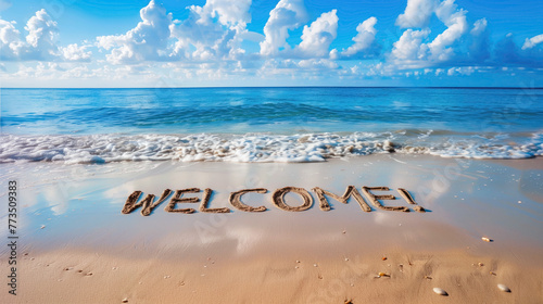 Welcome message on sandy beach with waves. Clear blue sky over tranquil sea with welcome text in sand © Denniro