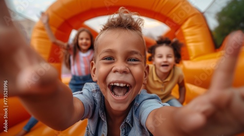 A group of children playing in a bouncy castle. 