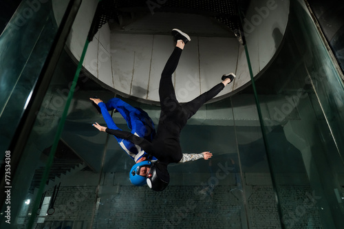 A man and a woman enjoy flying together in a wind tunnel. Free fall simulator