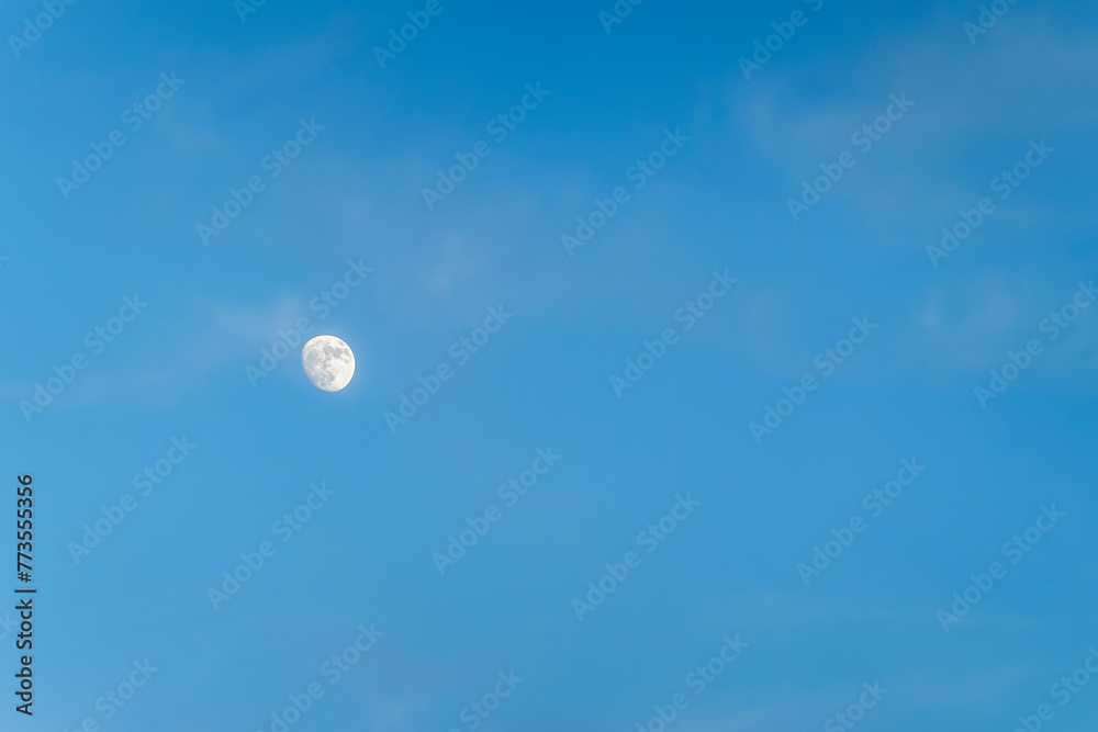 Miami, Florida, USA - July 29, 2023: Closeup of moon in blue sky Miami, Florida, USA - July 29, 2023: Closeup of moon in blue sky