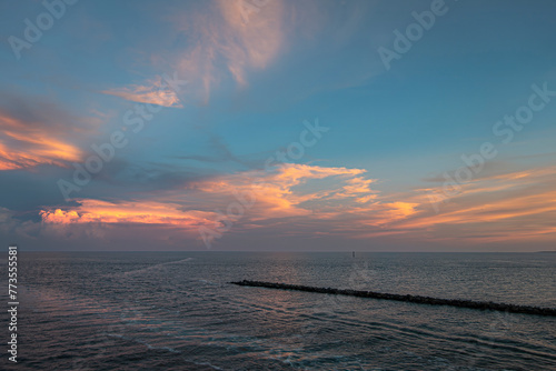 Miami, Florida, USA - July 29, 2023: Mushroom sunset cloud over Atlantic Ocean. Fisher Island NE pier upfront