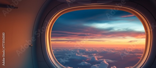 An airplane window with a stunning view of a vibrant sunset in the background
