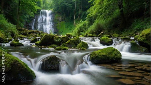Serene forest waterfall over mossy rocks © sitifatimah